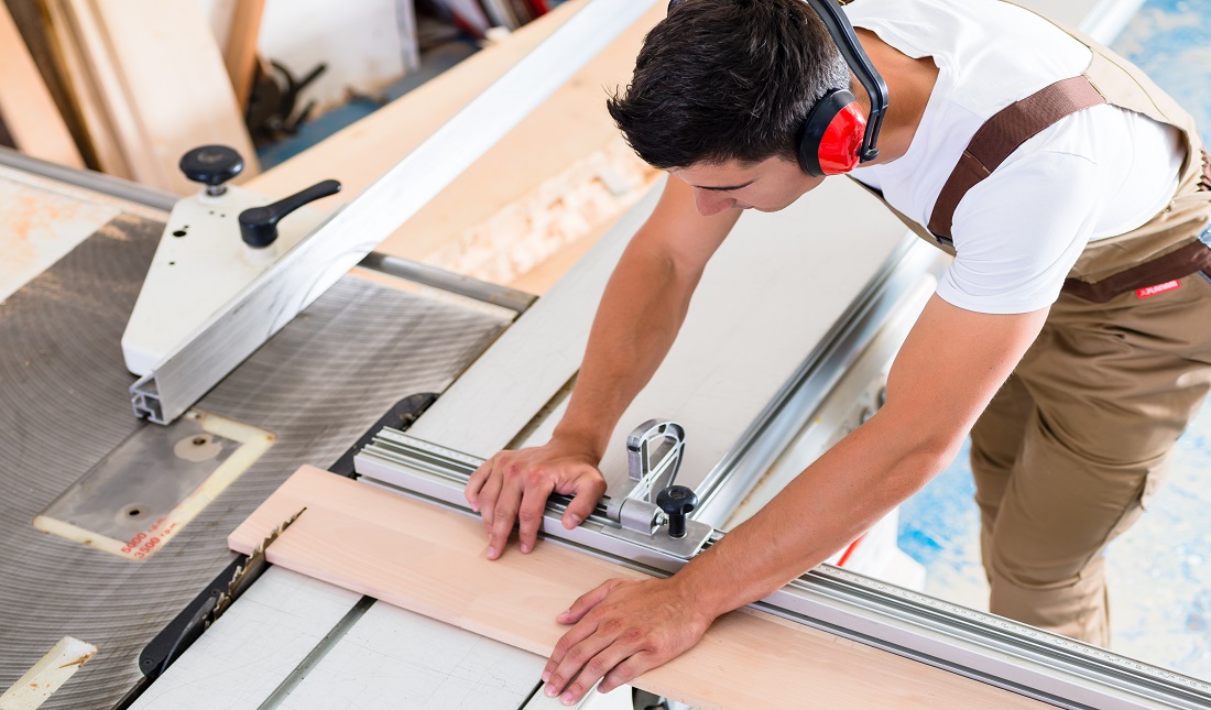 Carpenter or cabinet maker in his wood workshop
